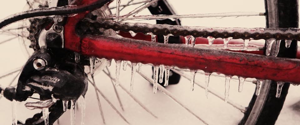 Icicles hanging from the chain stay and chain of a bicycle in freezing weather